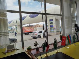 a window of a cocacola store with a view of a street at Quba ALFA-M Motel in Quba