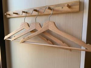 a bunch of wooden hangers on a door at Cardwell by the Sea in Cardwell