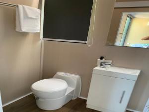 a small bathroom with a toilet and a sink at Cardwell by the Sea in Cardwell