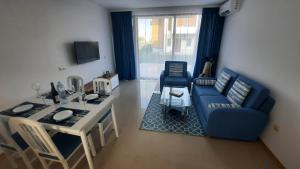 a living room with a blue couch and a table at Luxury Lighthouse Golf Villa in Balchik