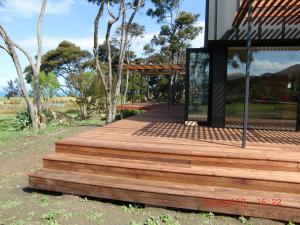 a wooden deck on a house with a bench on it at Lansdowne Farm in Hawkeswood