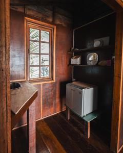 a kitchen with a sink and a small refrigerator at Beachfront Hut Upstairs Astra - Beach Shack Chalet in Tioman Island