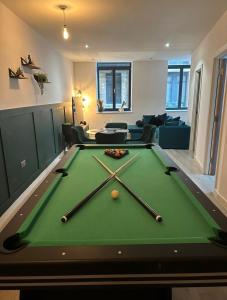 a living room with a pool table with cue balls on it at Dream Retreat Luxury Apartment with Super King Bed, Pool Table PS4 - Sleeps 5 Free Parking in Bradford