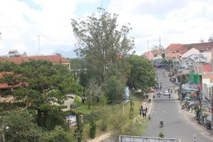 a view of a street in a town with people on the road at DaLat Sky Hostel in Da Lat