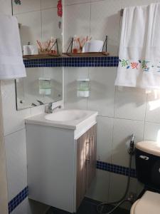 a bathroom with a sink and a mirror and a toilet at Apartamento frente al castillo San Felipe in Cartagena de Indias