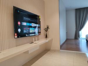 a living room with a flat screen tv on a wall at Quill Residence KLCC By Ezhome in Kuala Lumpur