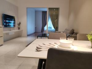 a living room with a table and a dining room at Quill Residence KLCC By Ezhome in Kuala Lumpur