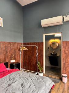 a bedroom with a red bed and a blue wall at The Loft House in Dimāpur
