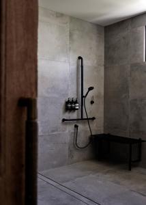 a bathroom with a shower in a concrete wall at Villa Riad in Ewingsdale