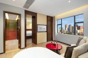 a living room with a view of a city at YZHI Hotel - Guangzhou Panyu City Bridge Subway Station in Guangzhou