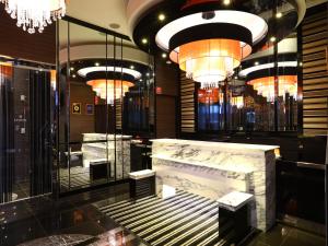 a lobby with a fireplace and chandeliers at APA Hotel Iidabashi Ekimae in Tokyo