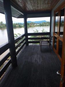 a porch with a bench and a view of a river at Sunset View-Villa in Pacific Harbour