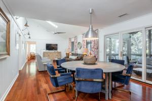 a dining room with a table and blue chairs at 478 Oceanwoods Cottage Lagoon View in Kiawah Island