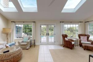a living room with skylights and chairs and a table at 81 Surfsong Rd in Kiawah Island