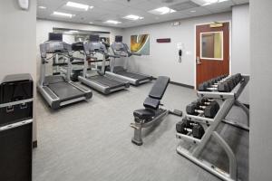 a gym with several treadmills and cardio machines at Courtyard Shelton in Shelton