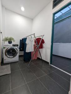 a laundry room with a washing machine and a washer at Private Homestay District 1, Tan Ðinh Ward, HCM City in Ho Chi Minh City