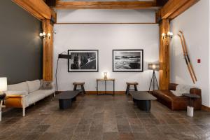 a living room with a couch and tables at Tantalus Resort Lodge in Whistler