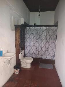 a bathroom with a toilet and a sink at Hotel Francisco's la Merced in Antigua Guatemala