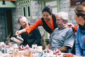 a group of people standing around a table at Mountain Lodges of Nepal - Thame in Thāmi