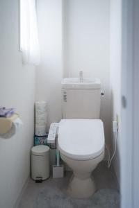 a bathroom with a white toilet and a phone at TuTuLu302 in Osaka