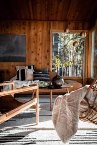 sala de estar con sofá y mesa en Mid-Century Cabin Perfect for Romantic Getaway, en Running Springs