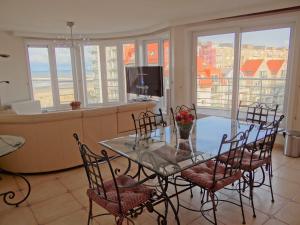 a dining room with a table and chairs with a view at Apartment Sea View 0604 with top location in Nieuwpoort