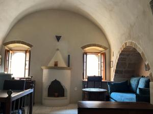 a living room with a couch and a fireplace at MONOVASIA SUITES Tholos Hammam in Monemvasia