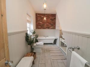 a bathroom with a sink and a bath tub at Harriet's Cottage in Whitby +19 photos