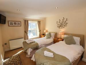 a bedroom with two beds and a window at Sea Shanty in Whitby