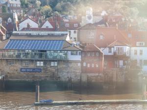 a view of a city with a river and buildings at Sea Shanty in Whitby