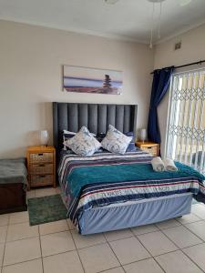 a bedroom with a large bed and a window at Dolphin View 402 Margate in Margate