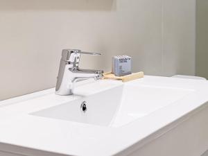 a bathroom sink with a faucet and a book on it at Majordoms - Ca les Cosines 48 in Banyoles +45 photos
