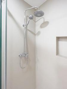 a shower with a shower head in a bathroom at Majordoms - Ca les Cosines 48 in Banyoles