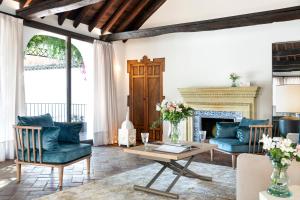 a living room with blue furniture and a fireplace at Gandesa, Palace House in Seville
