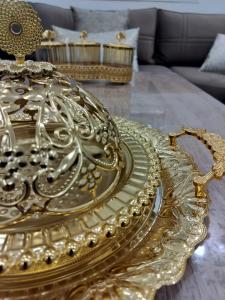 a gold platter on a table in a living room at Heaven of Fes in Fez