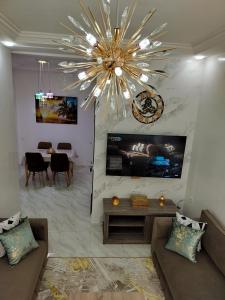 a living room with a large chandelier and a table at Heaven of Fes in Fez