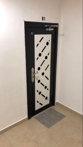 a black and white door with a bunch of wine bottles at City hotel in Sibu
