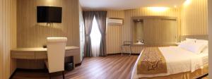 Rúm í herbergi á Mandarin Hotel Kota Kinabalu