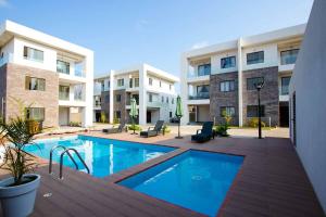 a swimming pool in front of a building at Stay Play Away Residences - Luxury 5 bed, Airport Residential in Accra