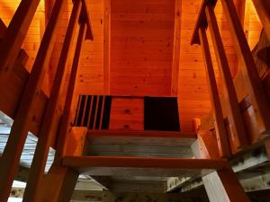 an inside view of a room with a wooden ceiling at Forest rest in Plužine