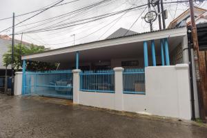 ein blau-weißes Gebäude mit einem Tor in der Unterkunft RedDoorz Syariah @ Sakura Hotel Jatiwaringin in Bekasi