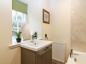 a bathroom with a sink and a mirror at South Mains Cottage - Craigievar Castle in Alford +33 photos