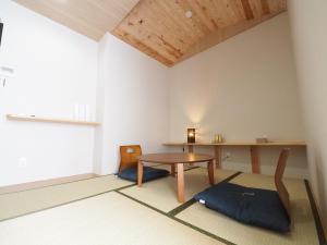 a small room with a table and a desk at locona +rakuta in Hyuga