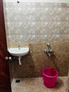 a bathroom with a sink and a pink bucket at Apartment near LNT & CTC & Airport - 3F in Chennai
