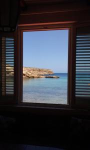 a window with a view of the ocean at B&B Cala Pisana (Paola e Melo) in Lampedusa
