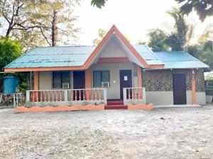 a small house with a blue roof at Ati Lodge Boracay in Boracay