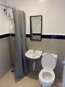 a bathroom with a toilet and a sink at Ati Lodge Boracay in Boracay