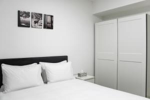 a bedroom with a white bed and a white cabinet at Luxury Suite Apartment #45 By Hashdera Eilat in Eilat