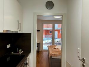 a kitchen with a table and a clock on the wall at sHome Apartments Graz - Self-Check-in & free parking in Graz