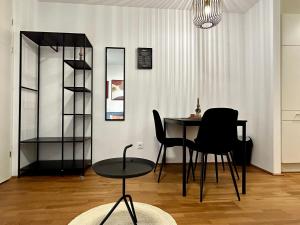 a dining room with a table and two chairs at sHome Apartments Graz - Self-Check-in & free parking in Graz